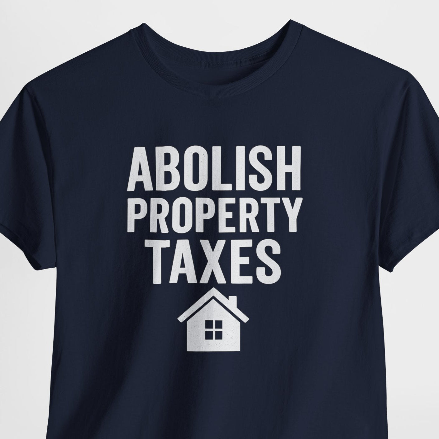 Navy blue t-shirt with 'Abolish Property Taxes' text and house icon on a light gray background