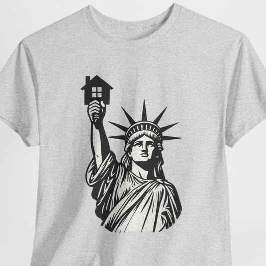 Gray t-shirt with a black and white graphic of the Statue of Liberty holding a house on a light gray background